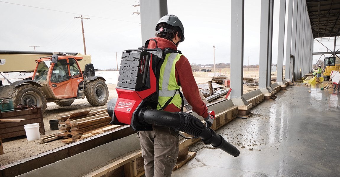 MILWAUKEE worker using cordless power tool on construction site